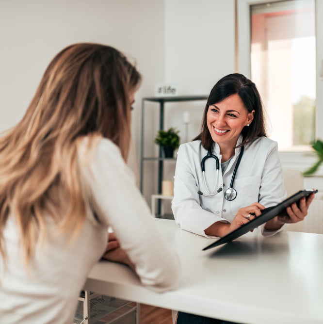 Female doctor explaining diagnosis to her young patient.